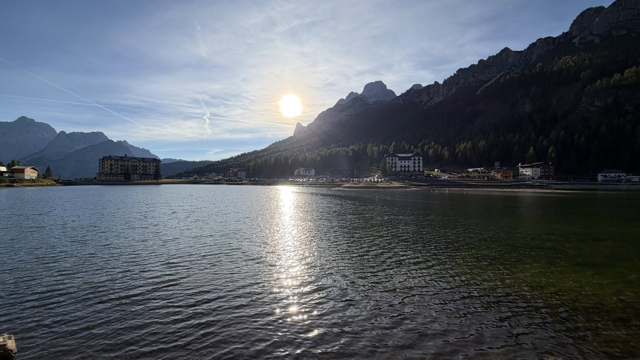 Il sole che scende dietro le montagne e accende l'acqua